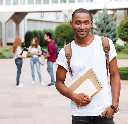 smiling-african-american-young-man-student-with-backpack-standing-outdoors-SBI-302782220.j