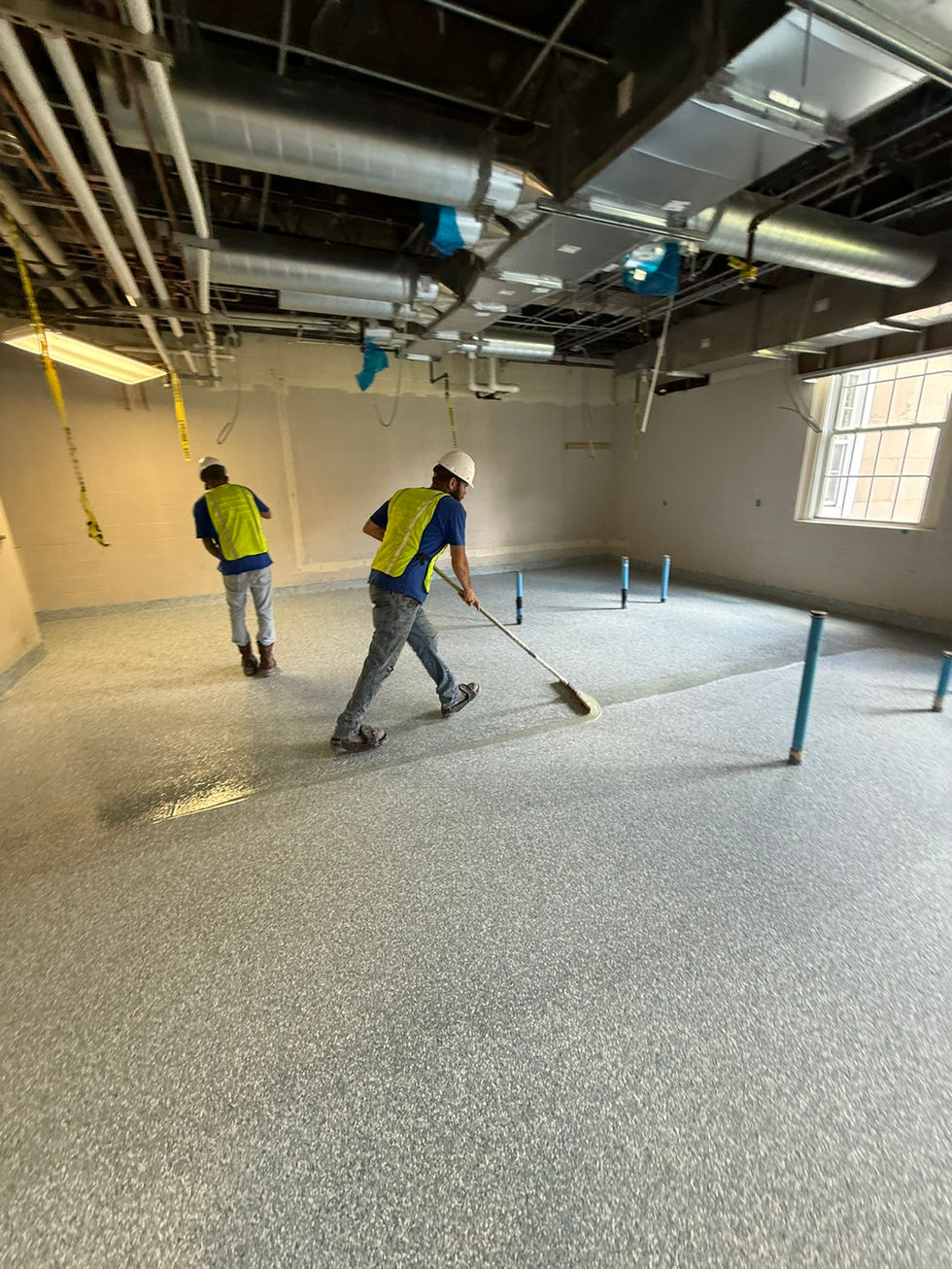 Bungay Flooring Systems crew installing commercial epoxy flooring in a large facility