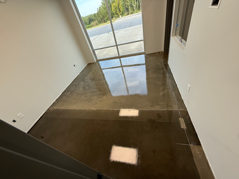Completed grind and seal concrete floor with reflective finish near large windows, sealed with two coats of H&C Concrete Sealer by Bungay Flooring Systems.
