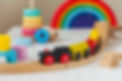 Colorful wooden train set with rainbow
