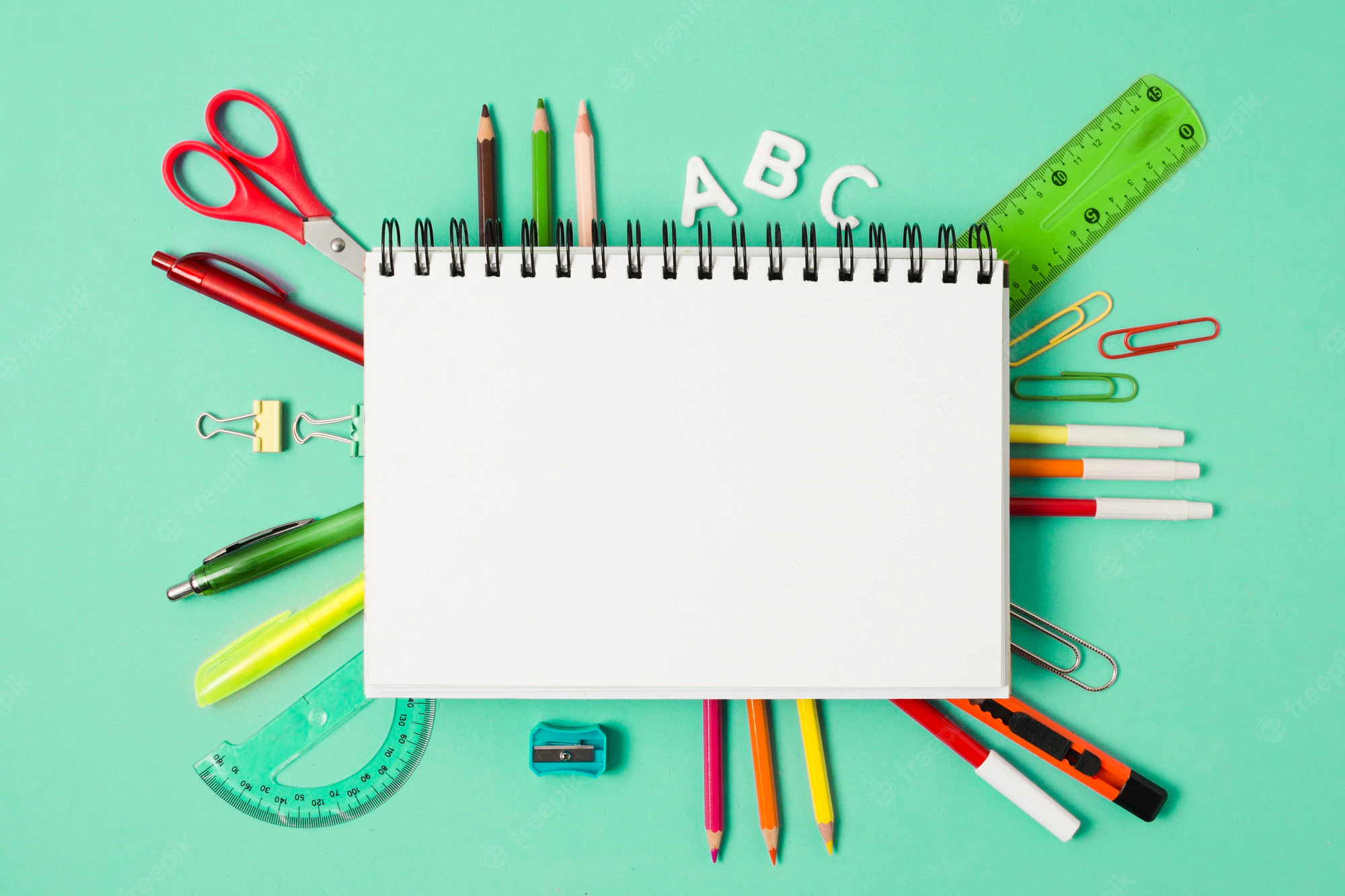 cuaderno-blanco-rodeado-utiles-escolares-papeleria_23-2148224242.webp