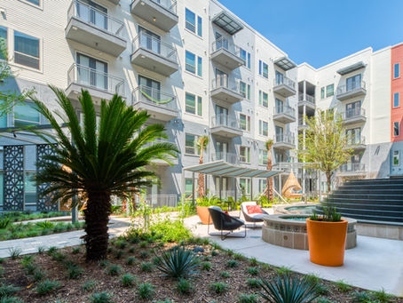 Modern South Florida apartment courtyard with palm landscaping, representing rental market shifts, multifamily housing, and property owner updates.