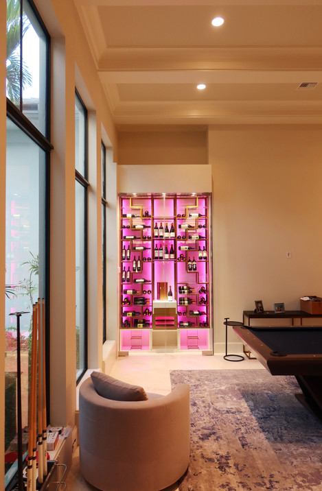 Custom wine wall Palm Beach featuring glass enclosure, illuminated bottle displays, and contemporary luxury wine storage by Dragon Cellars