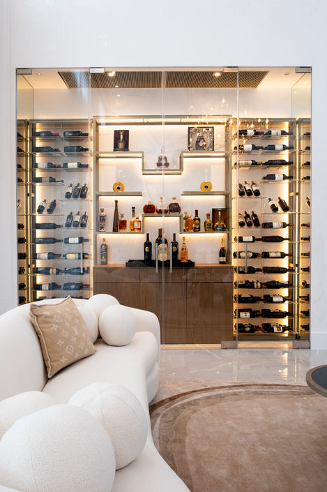 metal cable system wine racks with acrylic shelves, glass shelves module for spirits and decoration, wooden bottom cabinet for storage of wine glasses, decanters and accessories. Warm White LED Lights integrated, made in USA, wine wall, wine cellar, wine room, pinecrest, florida