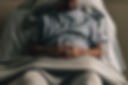 a-man-propped-up-in-hospital-bed-with-hands-crossed.jpg