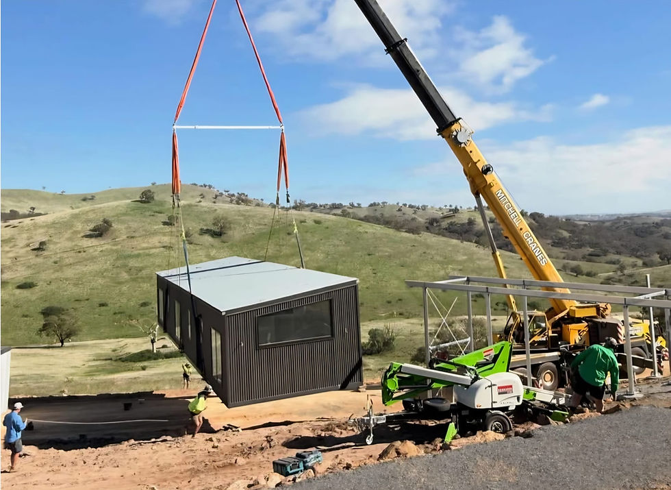 Mobile crane lifting a prefabricated building on site