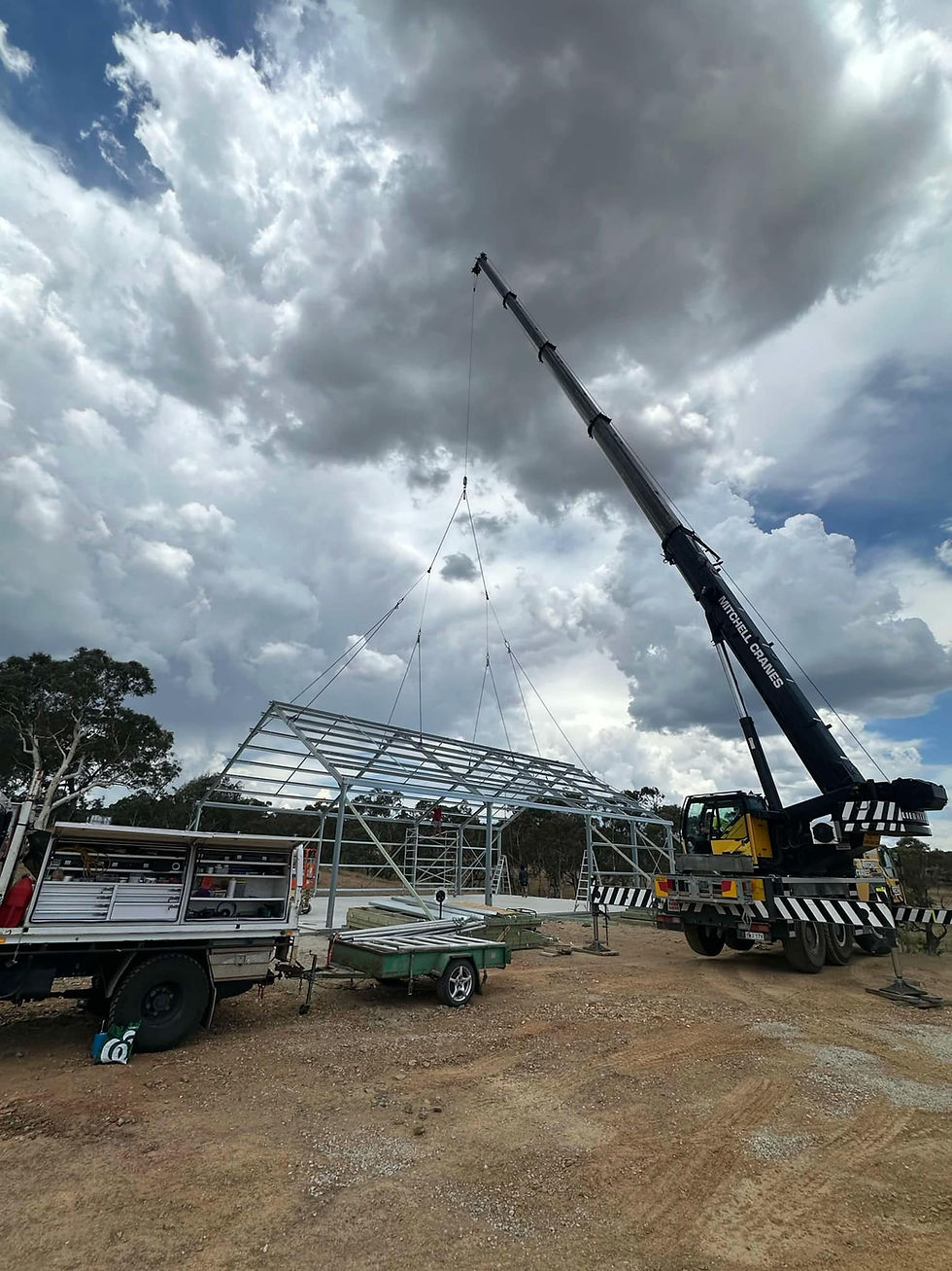 Mobile crane erecting structural steel columns and beams on a commercial building site