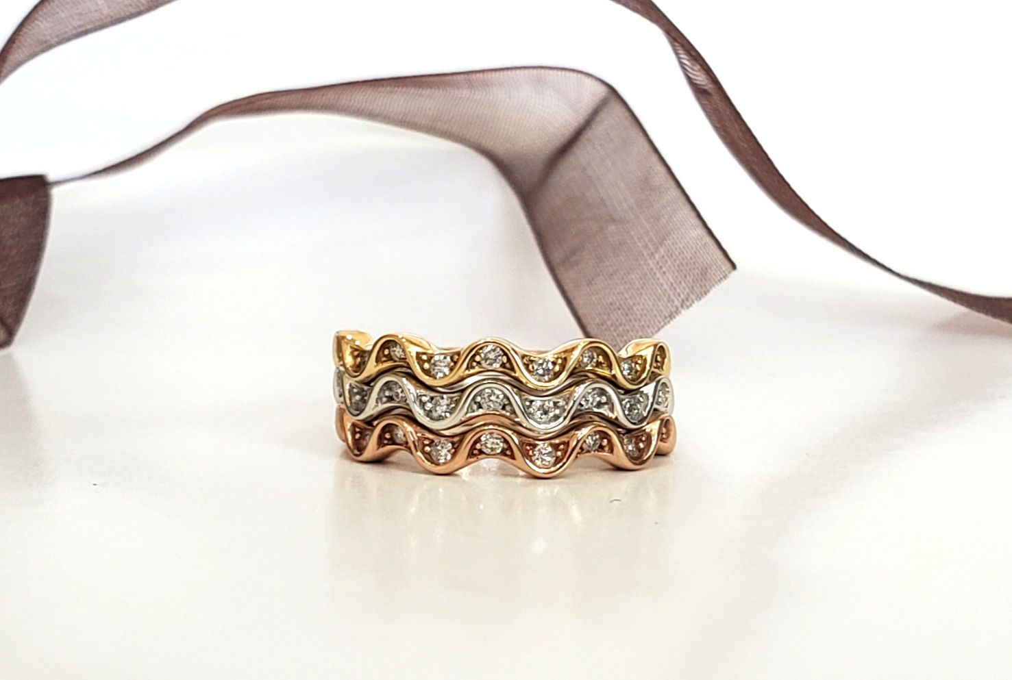 The rolling hills of West Virginia are playfully set with .08cttw of natural round diamonds. Available in 14k rose gold, yell