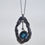 Thumbnail: molten sterling silver with a oval london blue topaz set in yellow gold with additional hanging diamonds