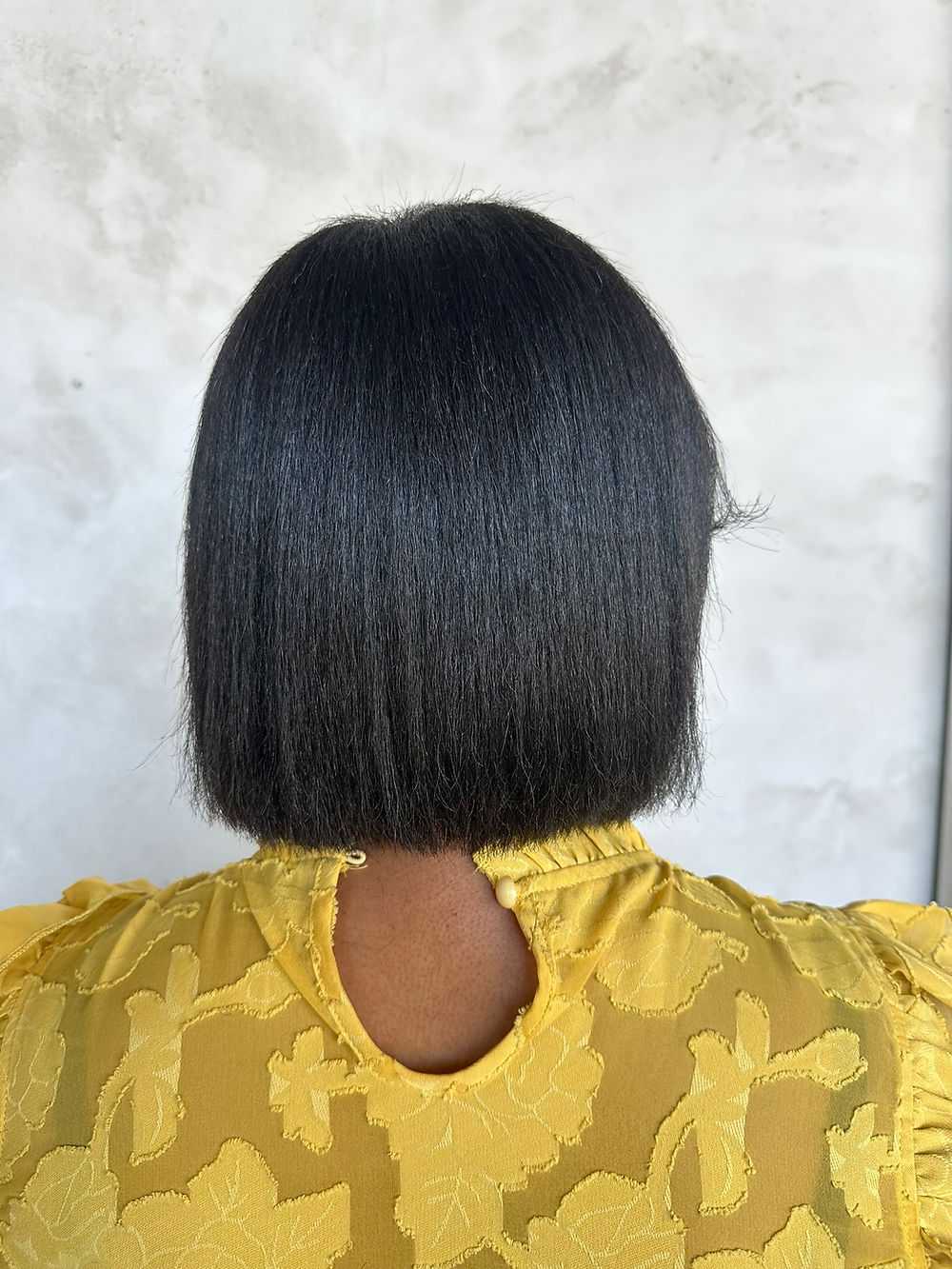 Silk press on natural textured hair by licensed cosmetologist in Peoria, Arizona.