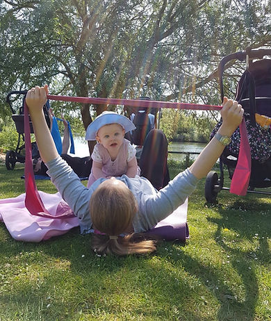 Mum & baby outdoors on yoga mat with resistance band