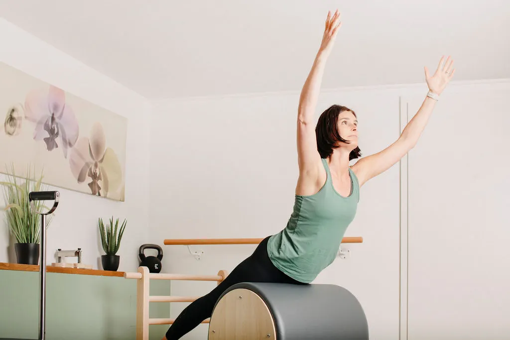 stéphanie oswald, coach de pilates chez Time 2 Pilates en train d'effectuer des ettirements sur des appareils de pilates apparatus.
