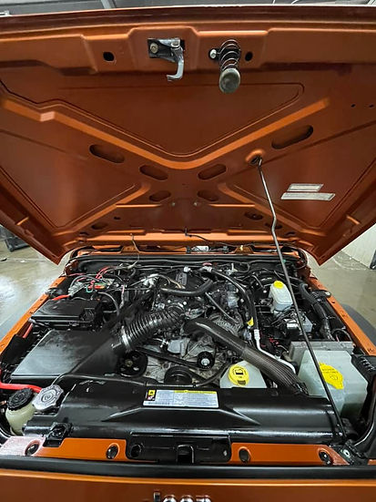 Sparkling clean engine bay after professional auto detailing service.