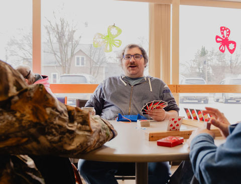 A group of participants plays cards together at CREATE main