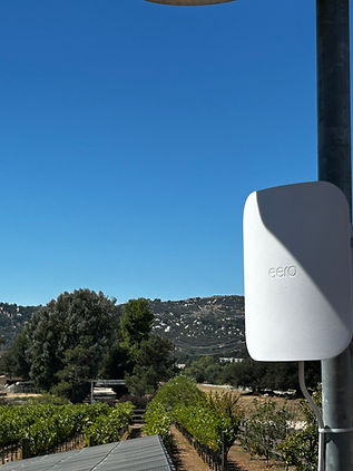 eero Outdoor 7 access point overlooking a vineyard for property-wide Wi-Fi coverage in La Cresta, California