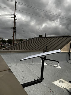 Commercial Starlink satellite dish installed on an adjustable wall-mounted bracket at Filippi's Pizza Grotto in Temecula, California.