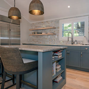 New custom kitchen with white oak flooring and built in appliances.  New wood ceiling beams and backsplash add a rustic vibe to this original stone house.