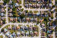 A photo of a neighborhood looking down from the sky. A drone shot.