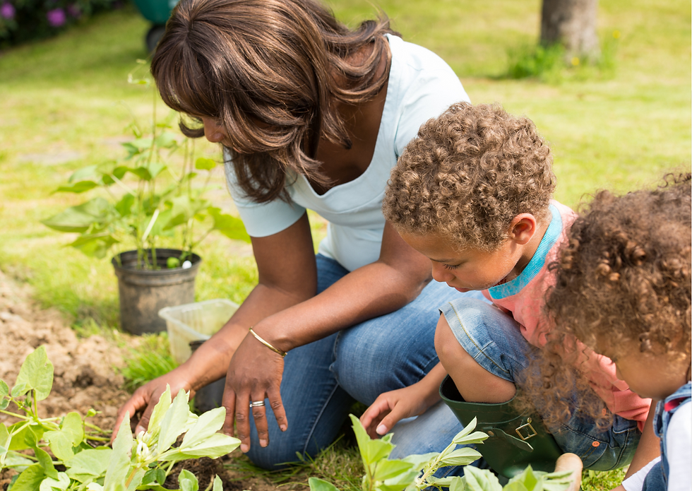 Toddlers gardening with parent