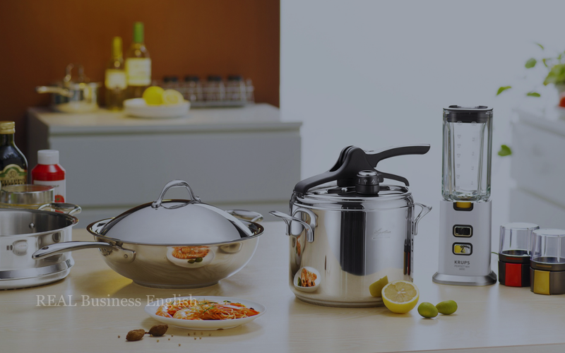 Stainless steel cookware, a pressure cooker, and a blender displayed on a kitchen counter.