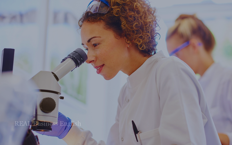 Medical researcher examining a sample under a microscope in a laboratory.