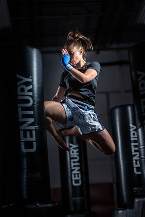 Adult woman training ladies kickboxing heavy bag workout NextGen Martial Arts Burlington women only program