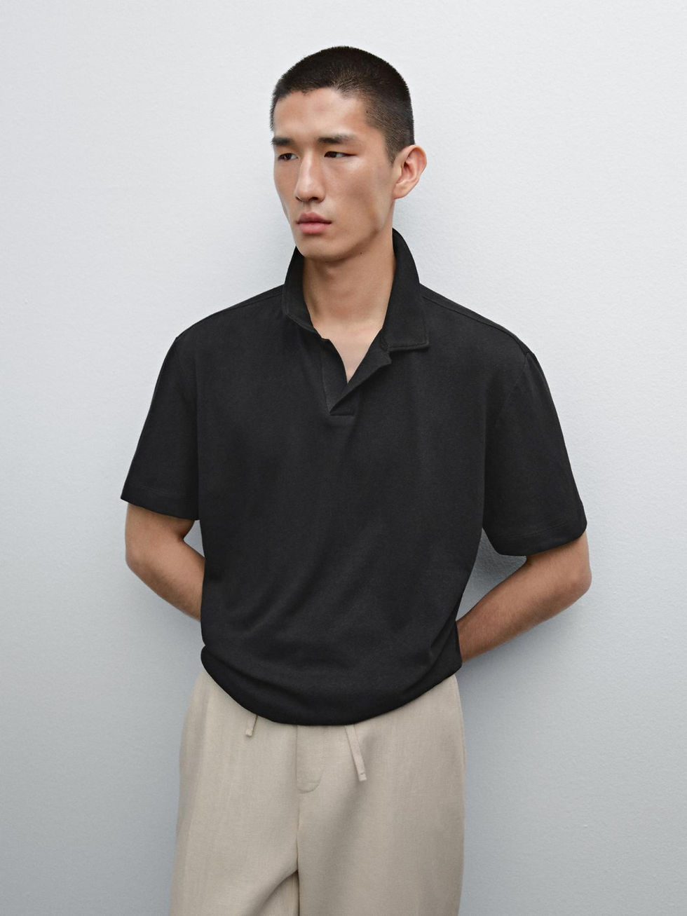 Massimo Dutti black V-neck knit polo on model, no buttons