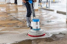 Floor specialist performing commercial floor scrubbing and cleaning with a floor machine in Frisco Texas