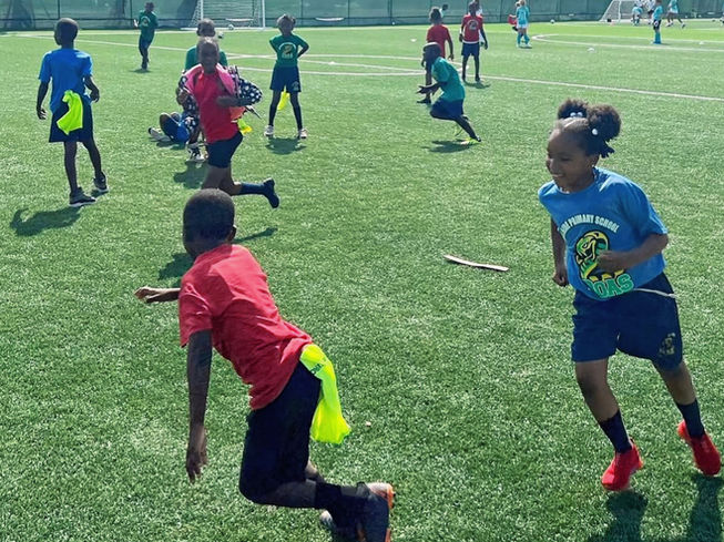 Adelaide Primary School students play flag football, during the Adelaide Auxiliary Soccer Programme in partnership with YESI, part of the broader Adelaide Auxiliary Sports Programme.