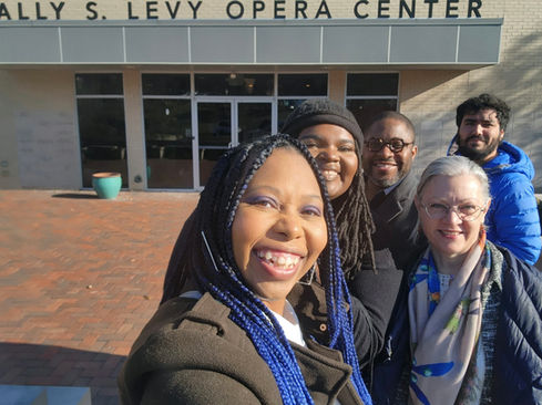 5 smiling creative artists stand out in front of the Sally Levy Opera Center in St Louis, MO.