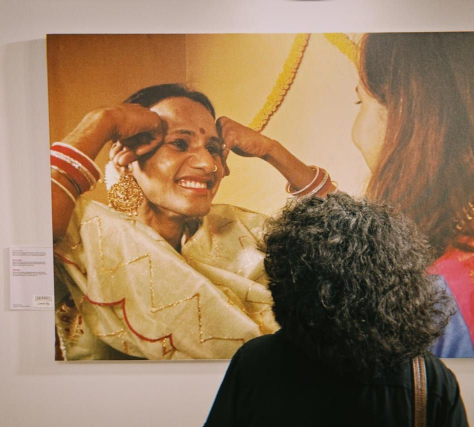 Photographer Raqeeb Raza with the pictures during the exhibition .