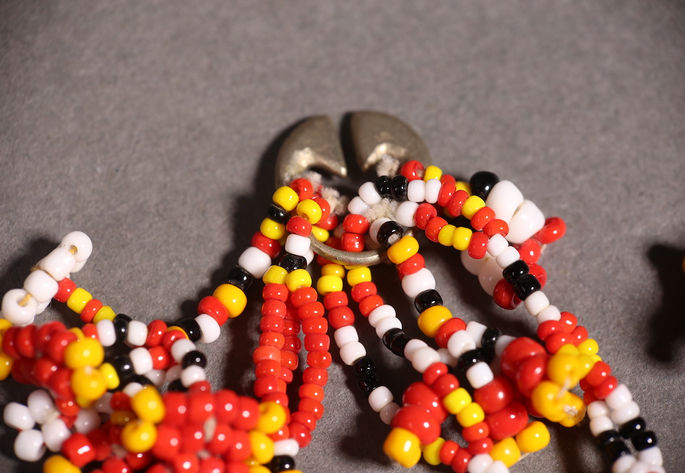 The red colour beads is dominant in this ear ornament
