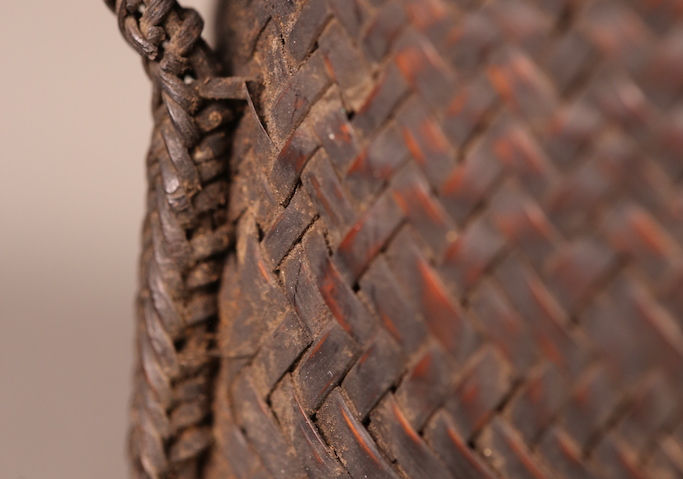 A weaved loop on the side of the basket for the attachment of the string