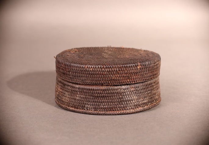 A small basket container with a round lid