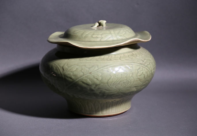 An olive ceramic jar