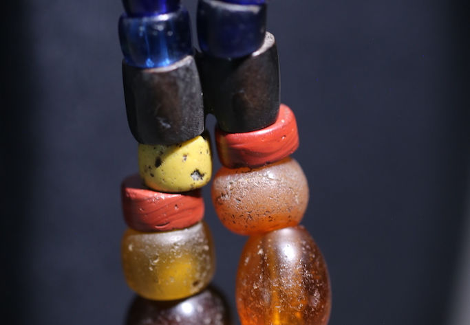 The black beads symbolises the earth and the blue beads symbolises clean water