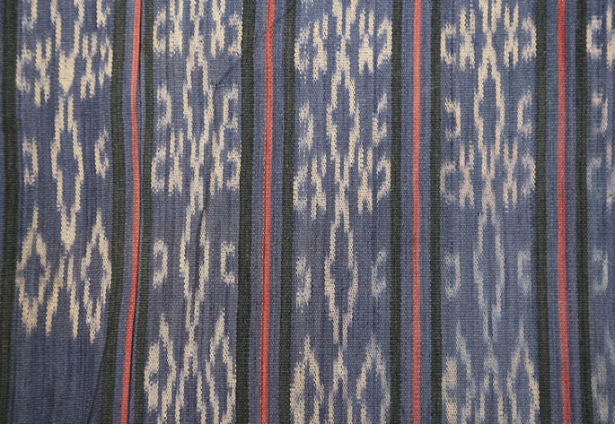 A detailed shot showing the white geometrical motifs that are interspersed with red and black stripes