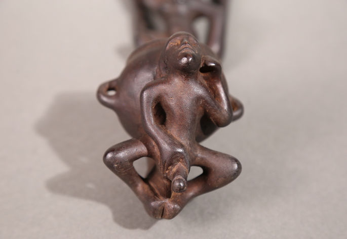 A closer look that shows a man holding its genital carved under the dipper’s bowl