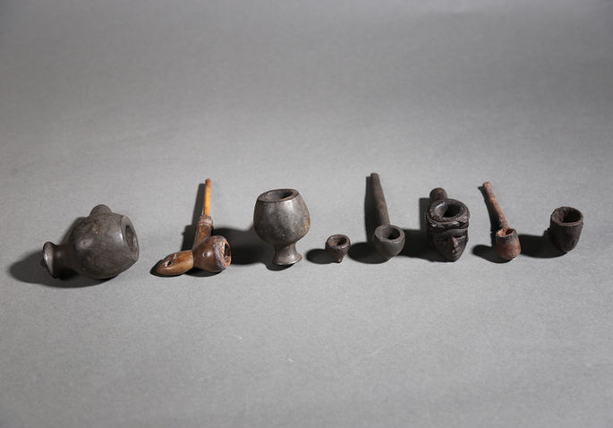 An assemblage of eight wooden pipes that varies in terms of carving designs and composition