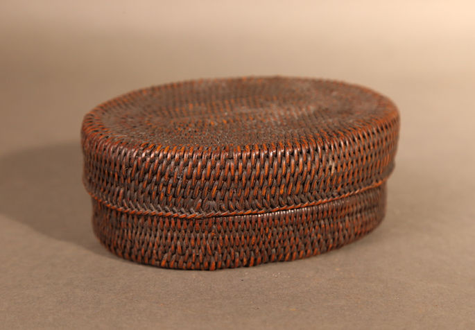 An old, small, oblong shaped container basket