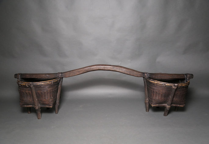 A huge carrying basket, called gimata, with arced pole that holds the two baskets on both ends