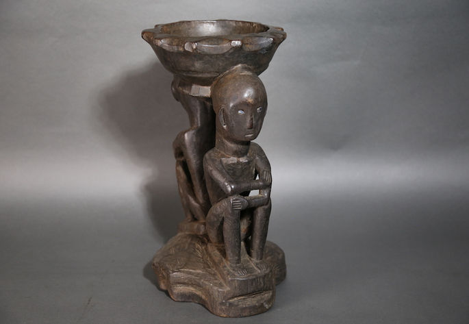 The figure stands on a roundish shaped base