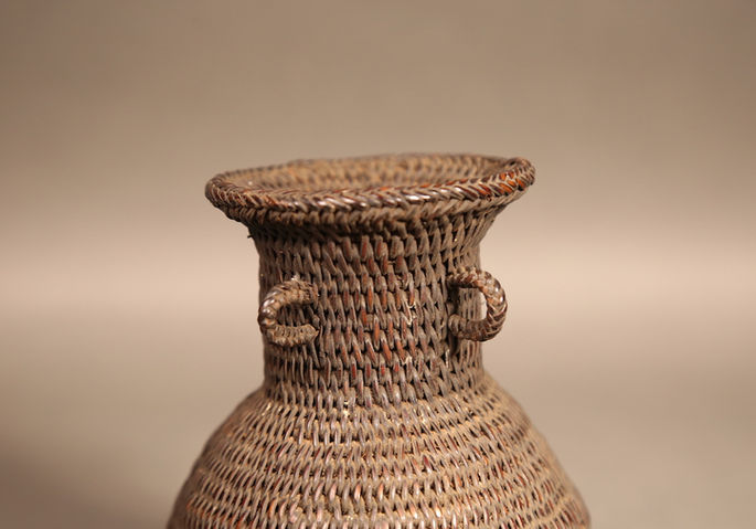 The elongated neck of the jar shaped aggawel basket
