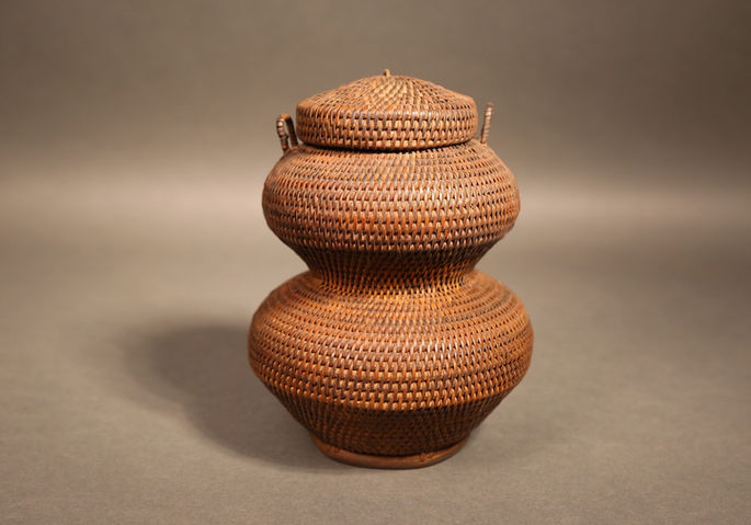 A miniature jar-shaped coiled rattan basket with a round lid