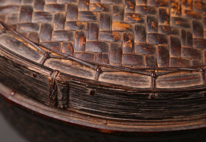 A closer look at the basket’s bamboo lid. Rattan splits were used to attach the woven rattan to the bamboo frame of the lid