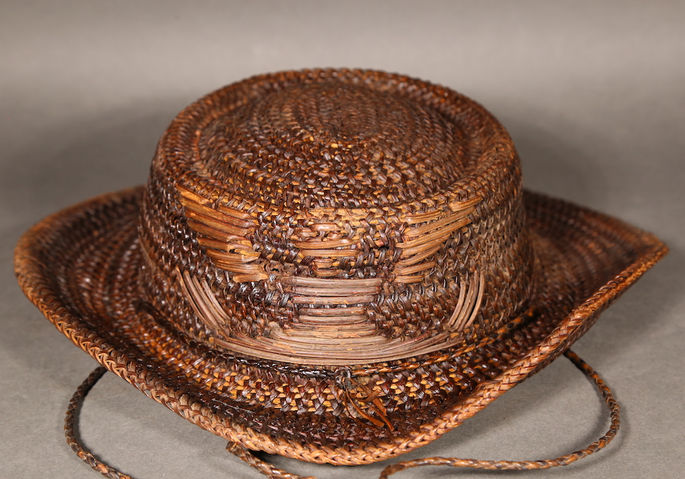 A dark brown woven cowboy hat inspired