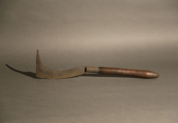 A hero shot of an Isnag hand axe that highlights its unique features including its curved blade and elongated tip