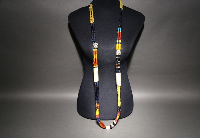 A large agate beads that is hang across the chest