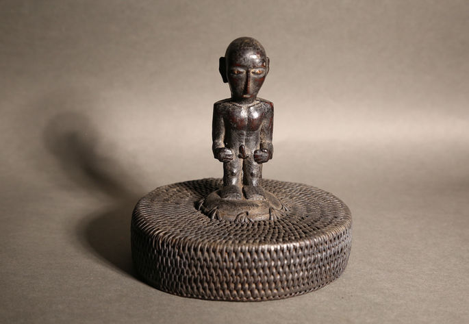 A bulul as a handle of a ceramic jar