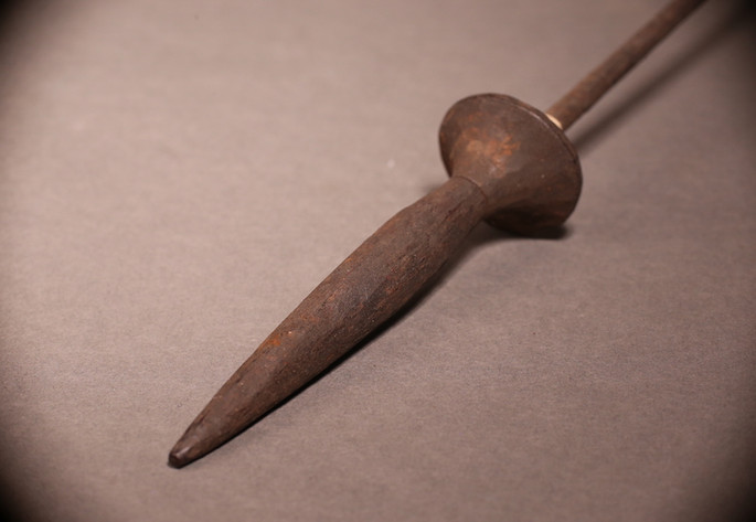 The dark brown wooden shaft